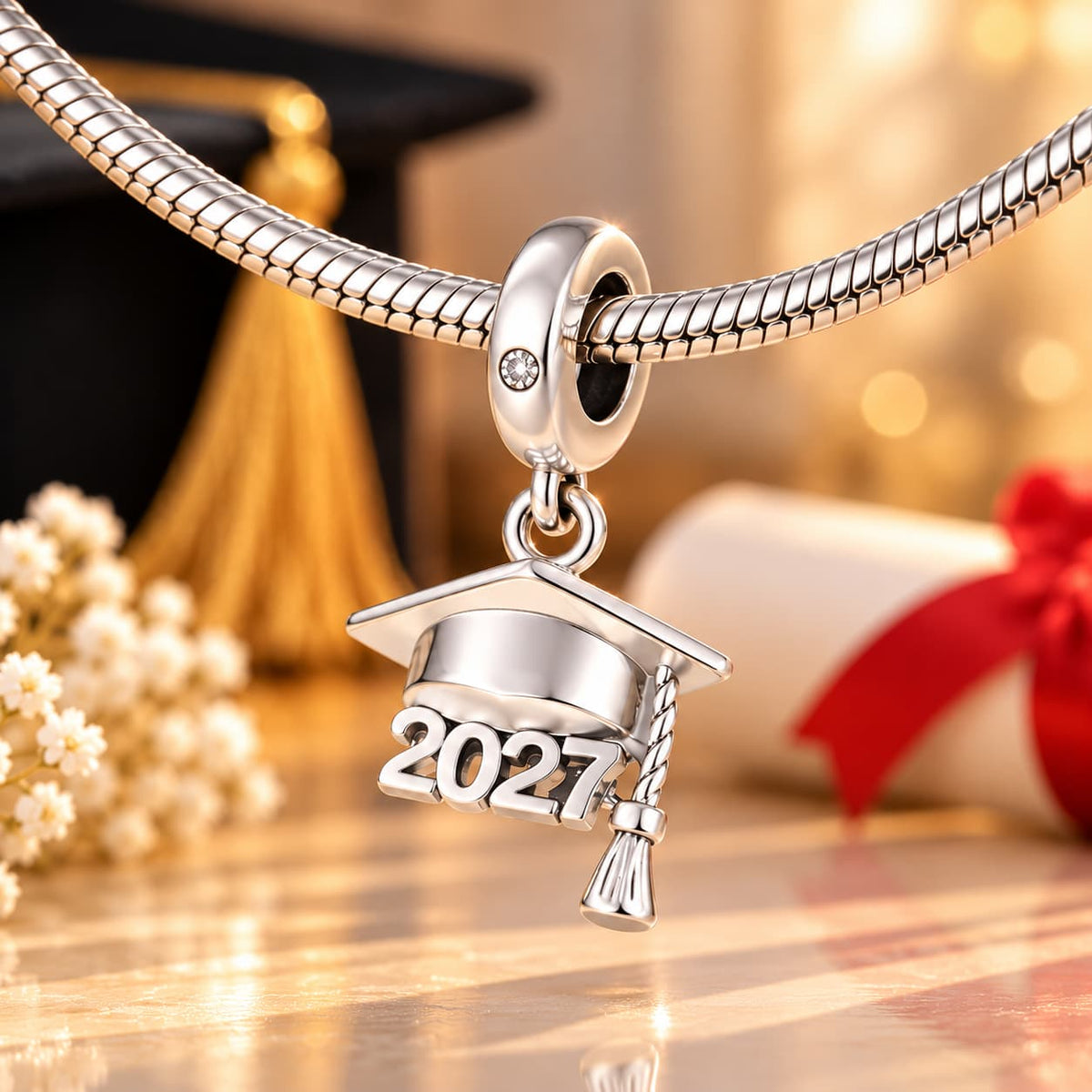 Close-up of the 2027 graduation charm threaded on a silver bracelet