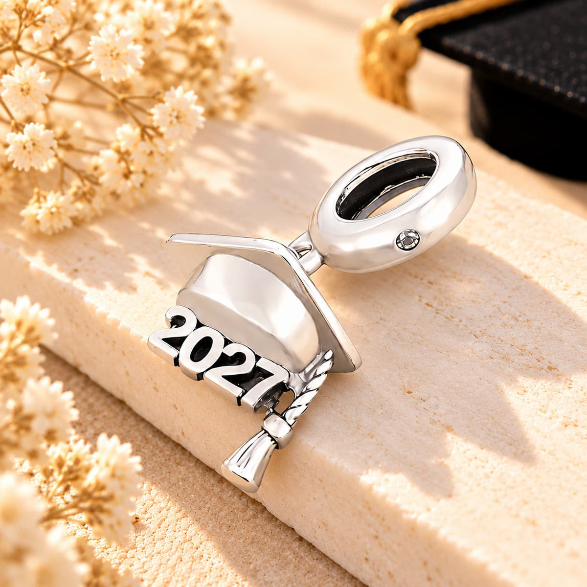 Side detail of the silver 2027 graduation cap charm