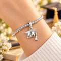 2027 graduation charm worn on a silver bracelet