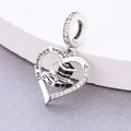 Close-up of graduation heart charm with black enamel academic symbols and sparkling zirconia