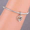 Graduation cap diploma and books details on a silver graduation heart charm