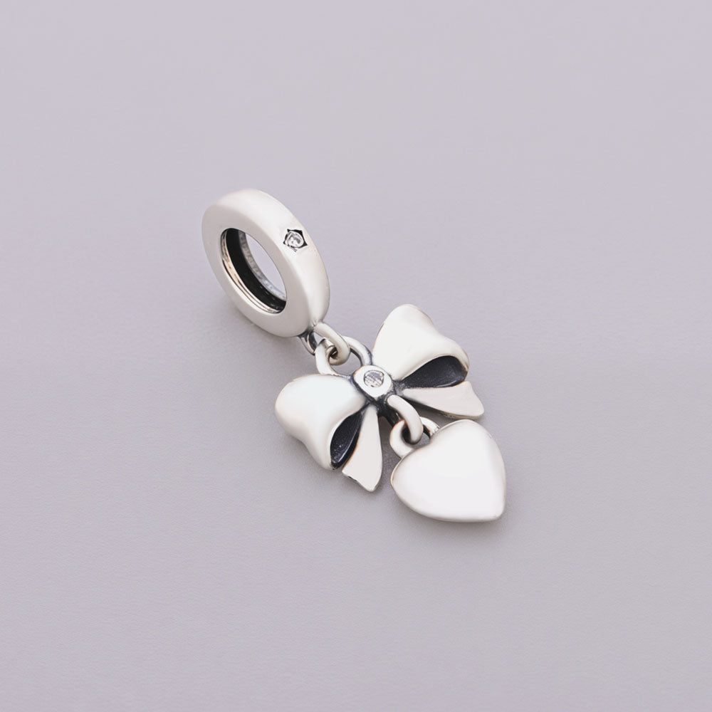 "Heartbound Rhythm" - 925 Silver Bow Knot & Tender Heart Dangle